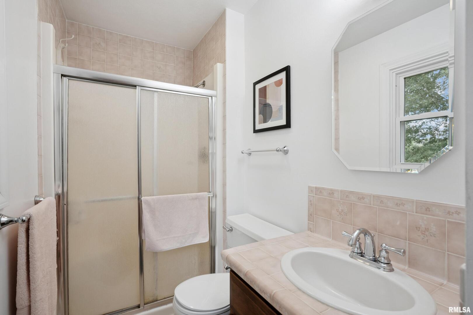 8528 101st Street West Andalusia, IL 61232 - Photo 21 of 42 a bathroom with a sink toilet and shower