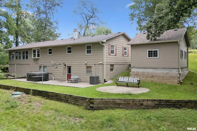 a white house that has a tree in front of it