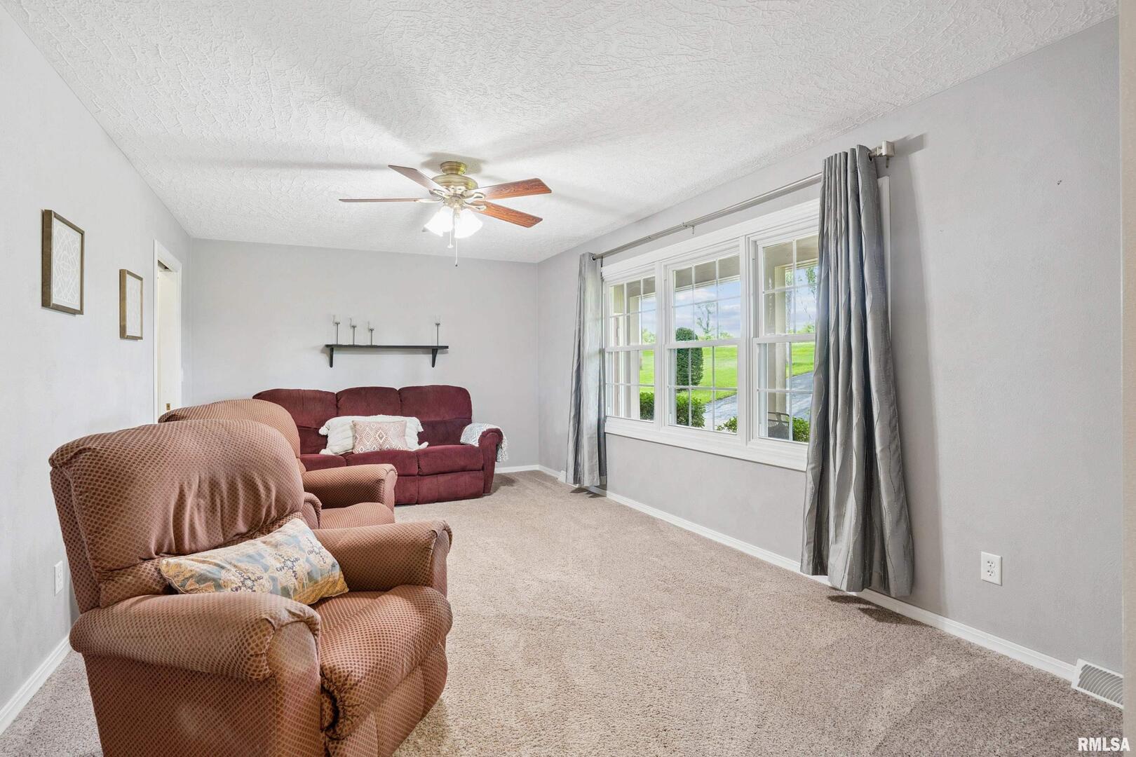 8528 101st Street West Andalusia, IL 61232 - Photo 6 of 42 a living room with furniture and a large window