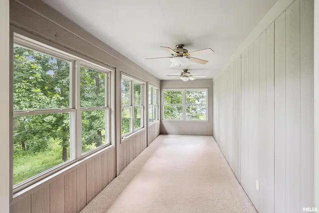 a view of a livingroom with a ceiling fan and window