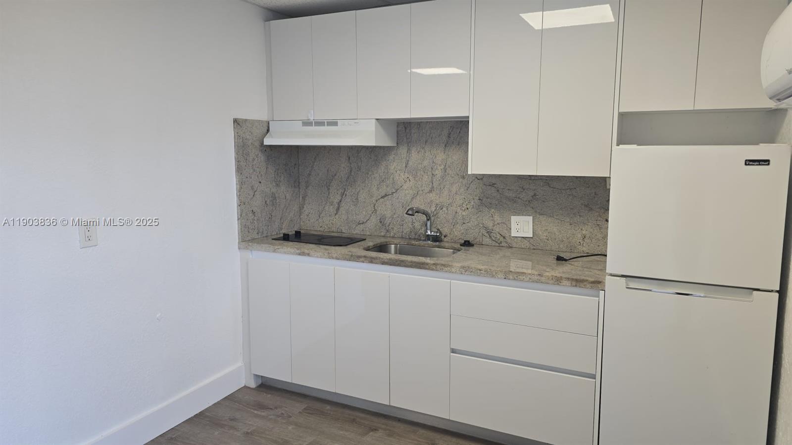 a kitchen with a sink and refrigerator