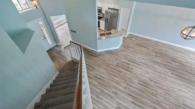 a view of entryway and hall with wooden floor