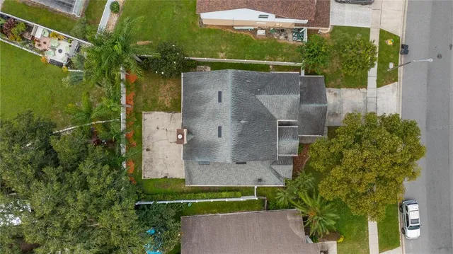 an aerial view of a house with a yard