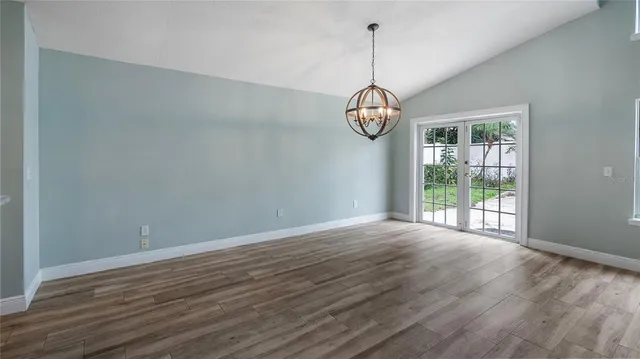 a view of wooden floor and windows in a room