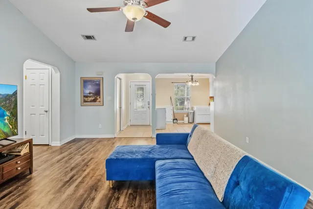 a bedroom with a bed and a flat tv screen on dresser