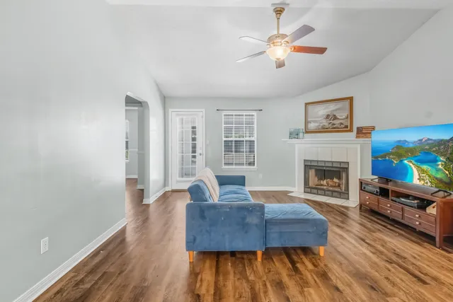 a living room with furniture and a floor to ceiling window