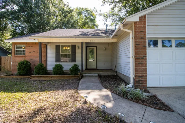 a kitchen with a stove a sink and cabinets