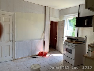424 Union Avenue, Unit 424 Bridgeport, CT 06607 - Photo 9 of 14 a kitchen with stainless steel appliances a stove a microwave and a refrigerator