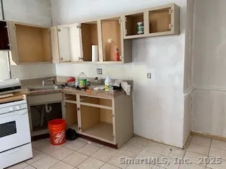 a utility room with a sink a stove and washer