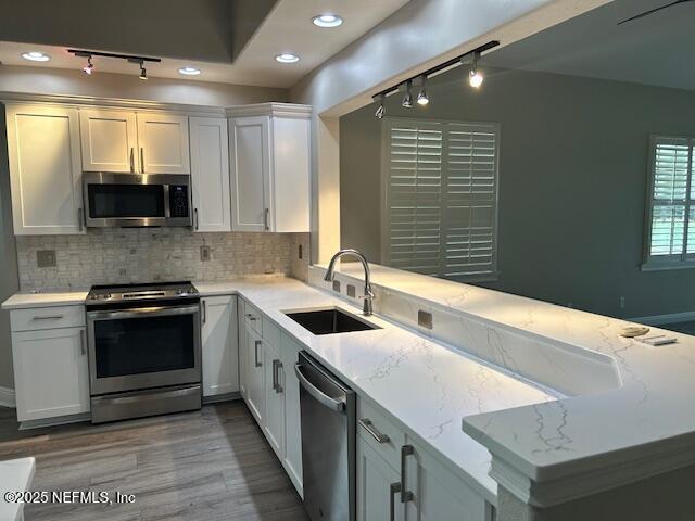 112 Laterra Links Circle, Unit 201 St. Augustine, FL 32092 - Photo 11 of 21 a kitchen with granite countertop a sink and a stove top oven
