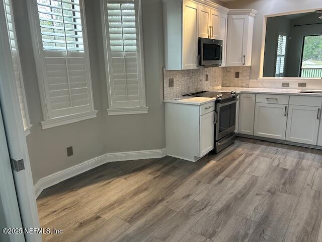 112 Laterra Links Circle, Unit 201 St. Augustine, FL 32092 - Photo 13 of 21 a kitchen with a sink stove and cabinets
