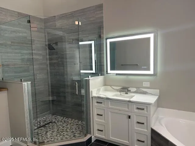 a bathroom with a shower sink and mirror