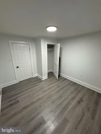 a view of an empty room and wooden floor