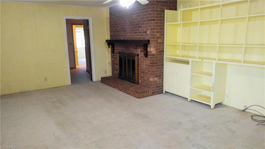 628 Peach Orchard Road Mayodan, NC 27027 - Photo 8 of 30 Den with fireplace and built-in shelves