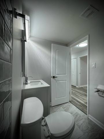 9720 South Pulaski Road, Unit 306 Oak Lawn, IL 60453 - Photo 7 of 12 a bathroom with a sink toilet and shower