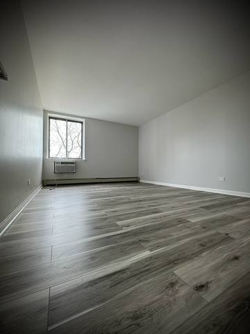 9720 South Pulaski Road, Unit 306 Oak Lawn, IL 60453 - Photo 9 of 12 an empty room with wooden floor and windows