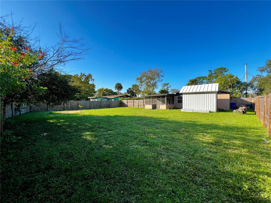 925 Lake Avenue Edgewater, FL 32132 - Photo 17 of 18 a view of a house with a big yard