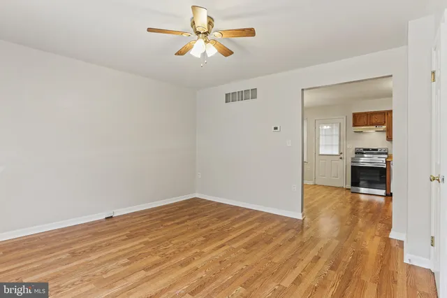 wooden floor in an empty room with a window