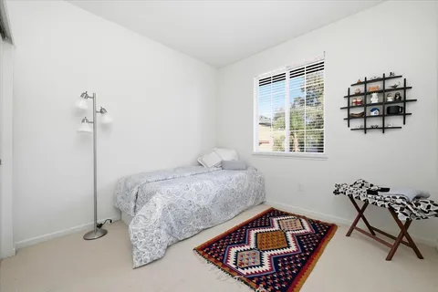 a bed room with a bed and a window