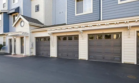 a view of a house with backyard sitting area and garden
