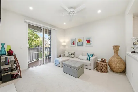 a bedroom with furniture and a large window