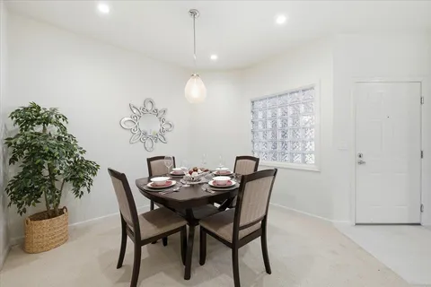 a dining room with furniture and window