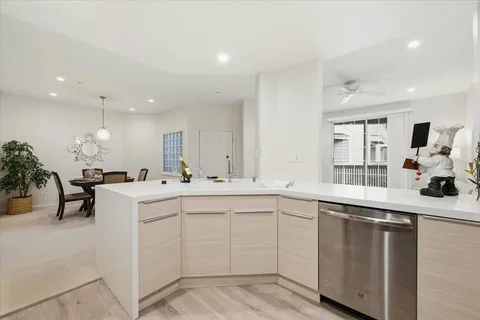 a kitchen with sink and white cabinets