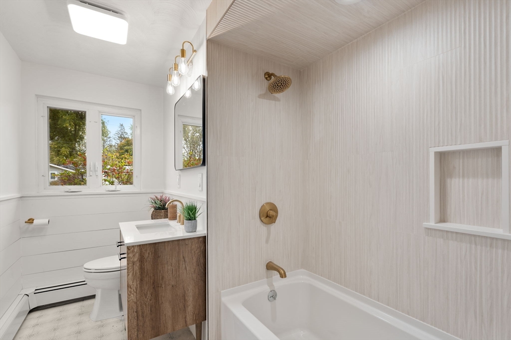 8 Clara Road Framingham, MA 01701 - Photo 12 of 41 a bathroom with a sink a toilet and shower