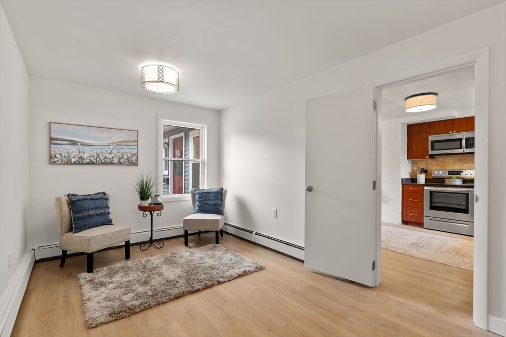 8 Clara Road Framingham, MA 01701 - Photo 8 of 41 a living room with furniture and a wooden floor