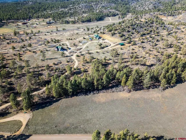 a view of a road with a yard covered with snow