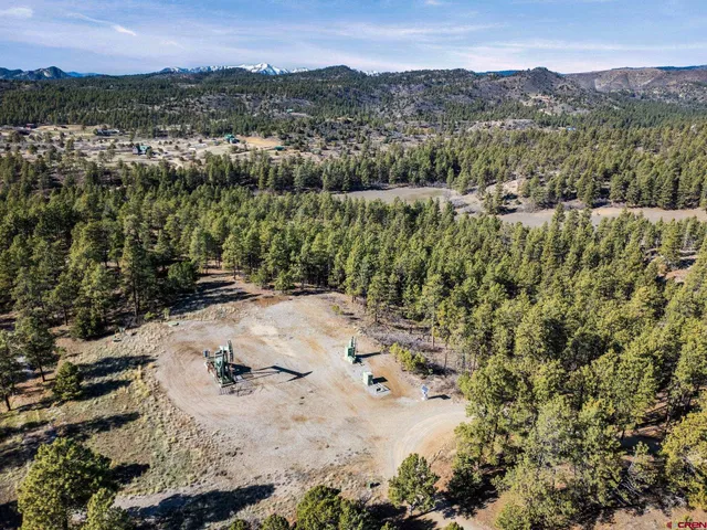 an aerial view of a houses with a yard