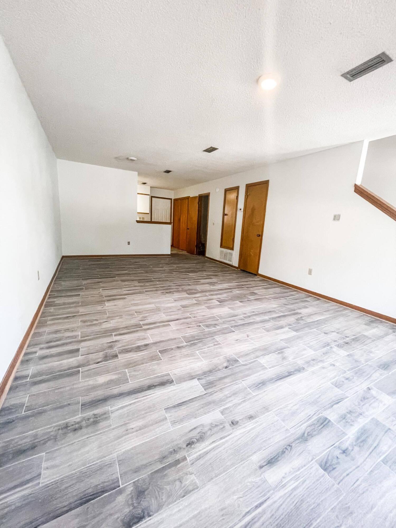 888 Culp Avenue, Unit 3 Fort Walton Beach, FL 32547 - Photo 4 of 12 a view of empty room with wooden floor