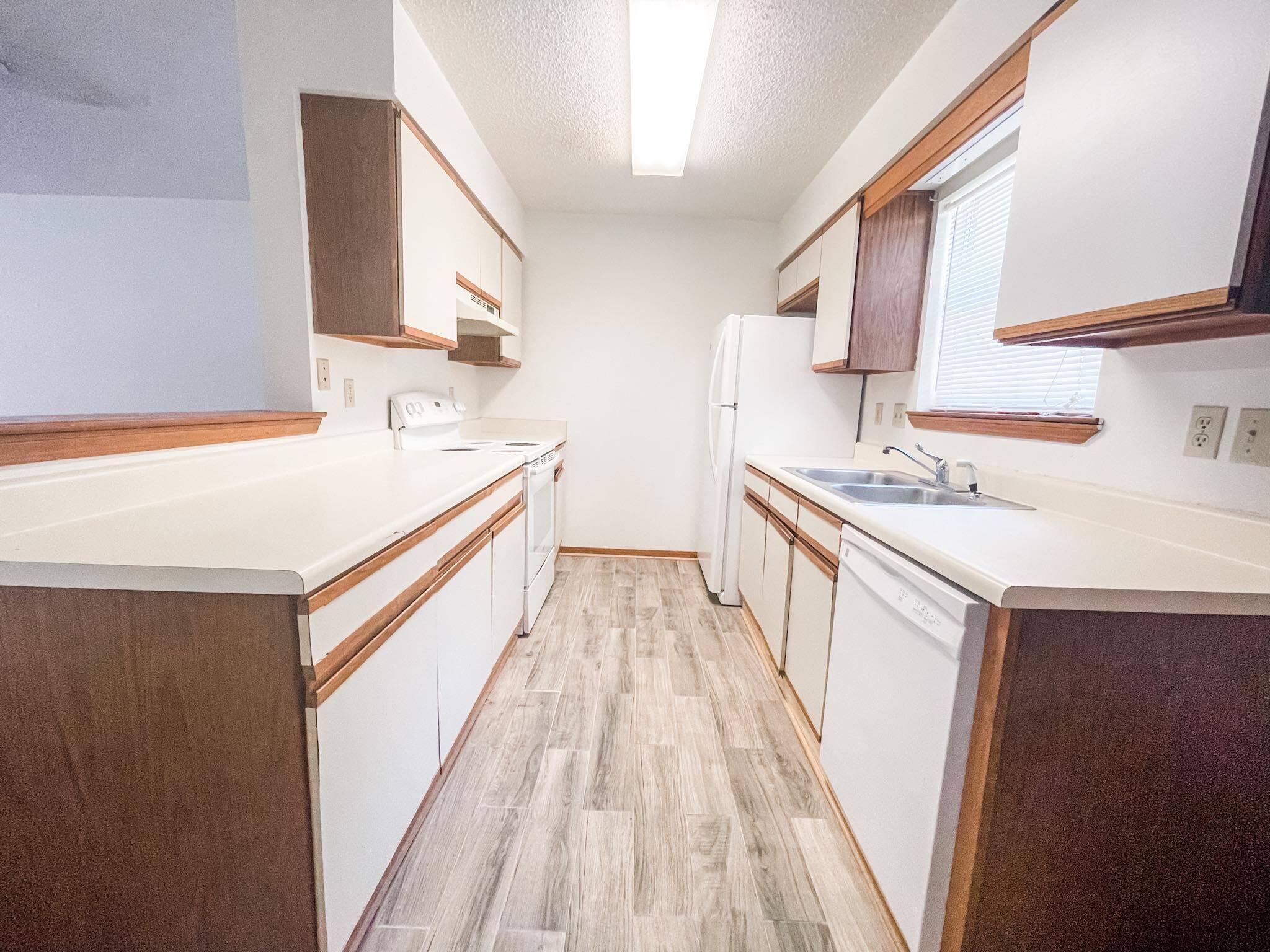 888 Culp Avenue, Unit 3 Fort Walton Beach, FL 32547 - Photo 7 of 12 a kitchen with a sink stove and a refrigerator
