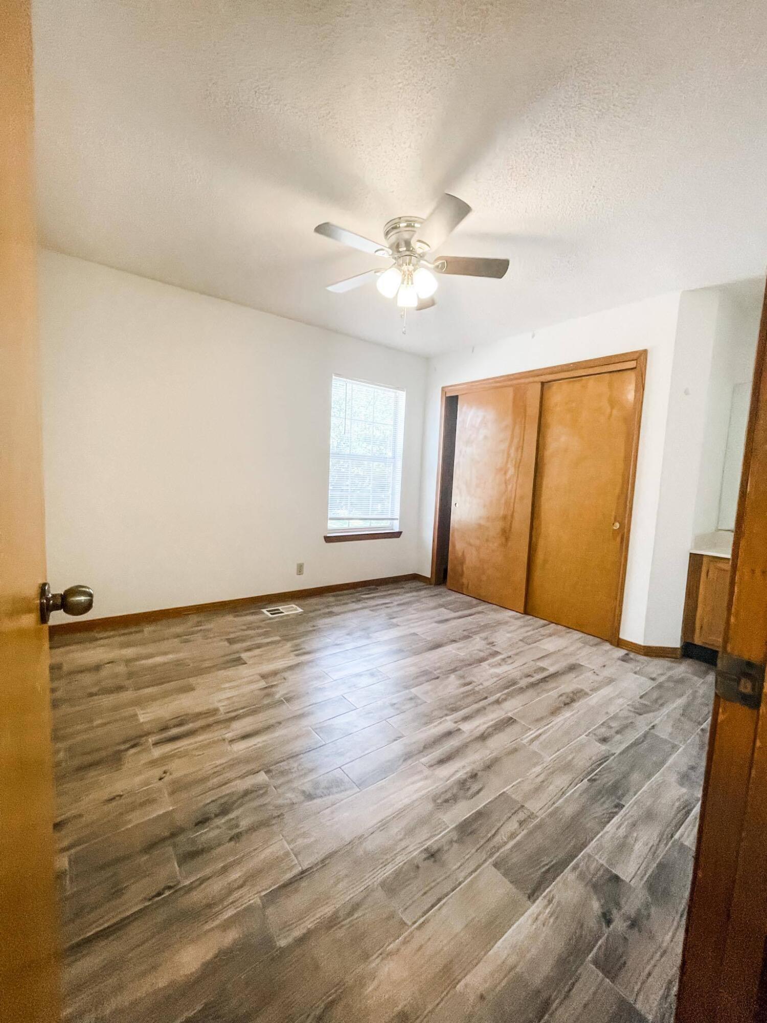 888 Culp Avenue, Unit 3 Fort Walton Beach, FL 32547 - Photo 10 of 12 wooden floor in an empty room with a window