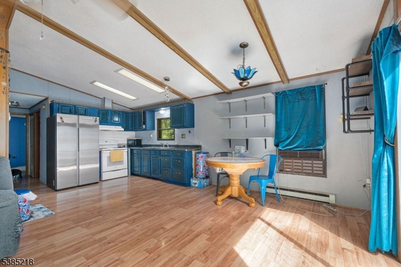 126 Armstrong Road Montague, NJ 07827 - Photo 13 of 28 a kitchen with stainless steel appliances wooden floors and wooden cabinets