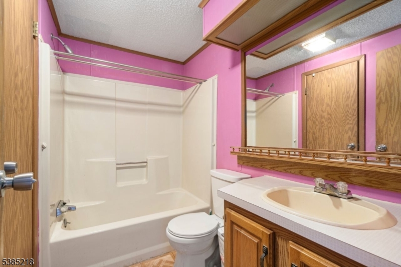 126 Armstrong Road Montague, NJ 07827 - Photo 16 of 28 a bathroom with a sink a toilet a mirror and a bathtub