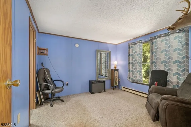 a bedroom with furniture and a large window