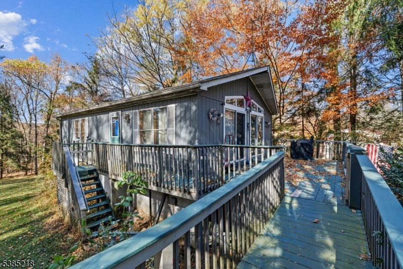 126 Armstrong Road Montague, NJ 07827 - Photo 2 of 28 a balcony with wooden floor stairs and wooden fence