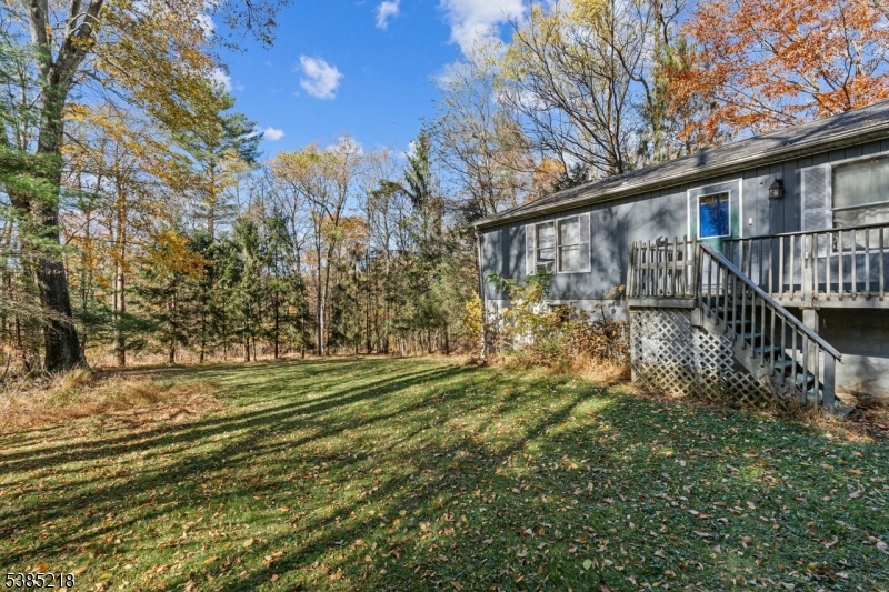 126 Armstrong Road Montague, NJ 07827 - Photo 26 of 28 a view of a house with a big yard and large trees