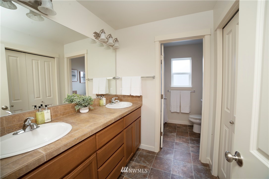 22206 32nd Avenue Southeast Bothell, WA 98021 - Photo 22 of 26 a bathroom with a granite countertop sink and a mirror