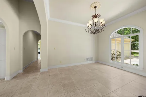 a kitchen with stainless steel appliances granite countertop a stove a sink a refrigerator a microwave and white cabinets