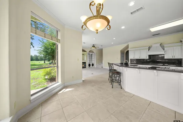 a view of a kitchen with refrigerator and a sink