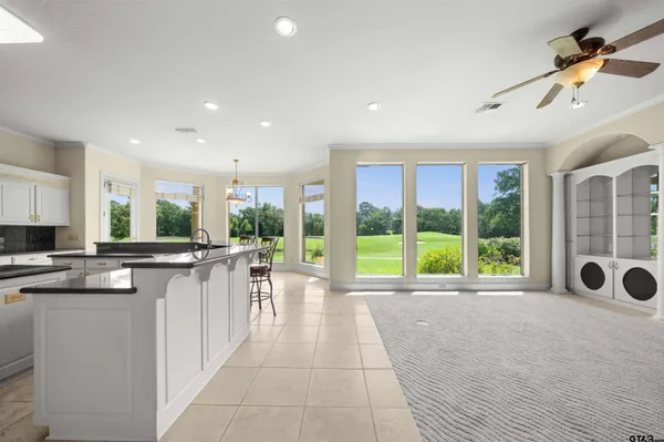 a large bathroom with a large mirror vanity and a shower