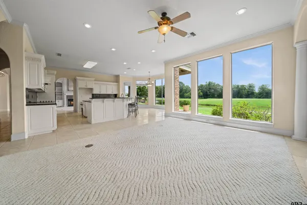 a spacious en suite bathroom with a double vanity sink a mirror and a bathtub