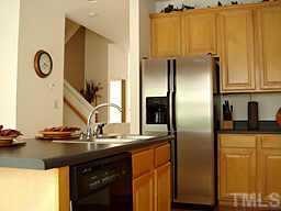 7204 Doverton Court Raleigh, NC 27615 - Photo 2 of 10 a kitchen with stainless steel appliances granite countertop a refrigerator and a sink