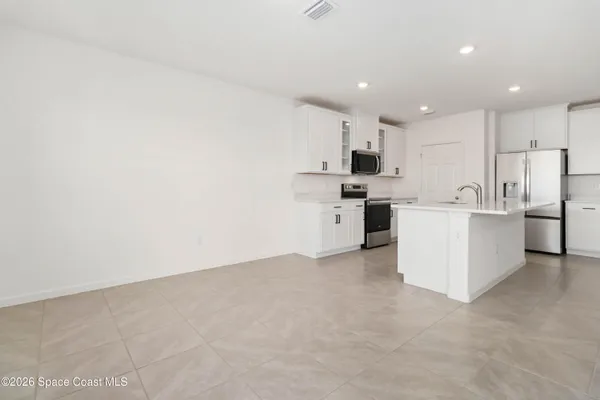 a bathroom with a tub a sink and mirror
