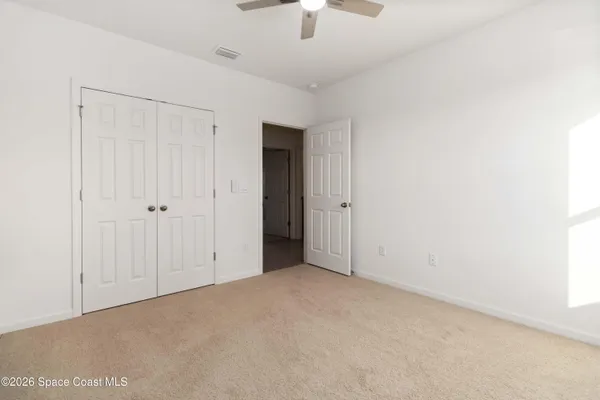 a living room with furniture a chandelier and a window