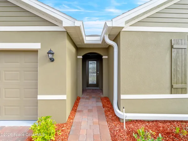 a large kitchen with stainless steel appliances granite countertop a stove a sink a refrigerator and white cabinets with wooden floor