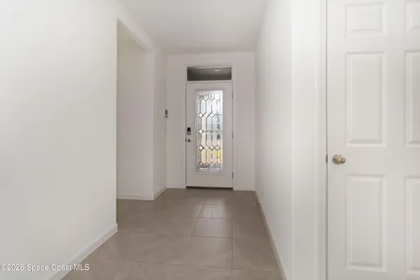 a large white kitchen with stainless steel appliances lots of white cabinets