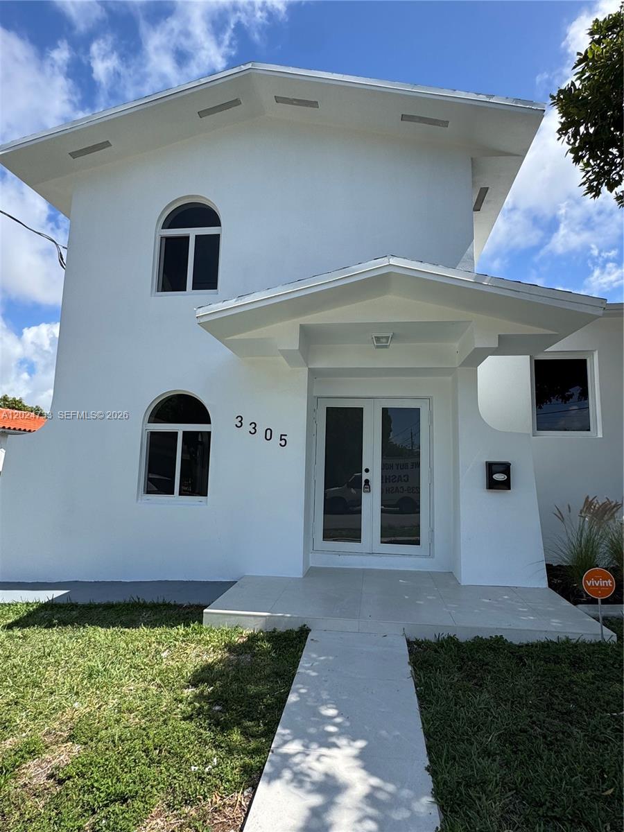 3305 Southwest 28th Street, Unit 3305 Miami, FL 33133 - Photo 2 of 17 a front view of a house with garden